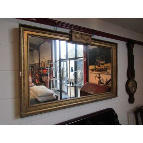 1013 - A 19th Century gilt and gesso framed rectangular wall mirror with swag embellishment, 77cm x 120cm t... 