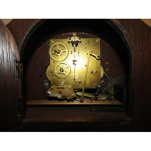 1023 - An oak cased mantel clock having Westminster and Whittington chimes.  With key