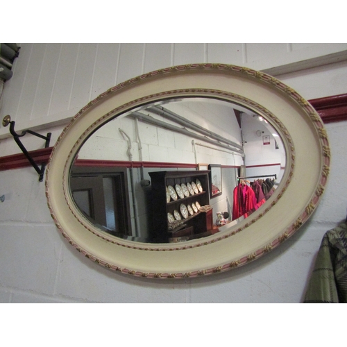 1031 - An oval mirror with painted frame, 55cm x 80cm total