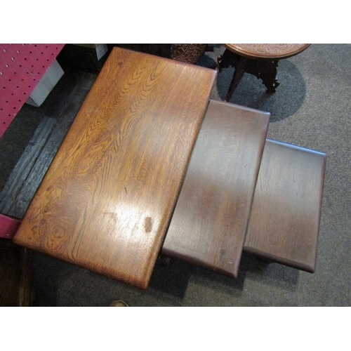 1066 - A nest of three Old Charm oak tables, with label, largest 45cm tall x 60cm wide x 33cm deep