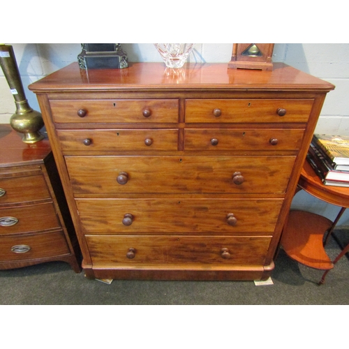 1073 - A Victorian mahogany chest of four short over three long drawers with bun handles on plinth base, a/... 