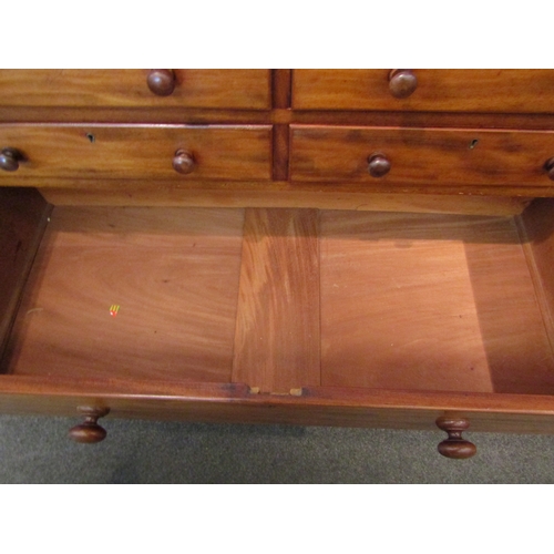 1073 - A Victorian mahogany chest of four short over three long drawers with bun handles on plinth base, a/... 