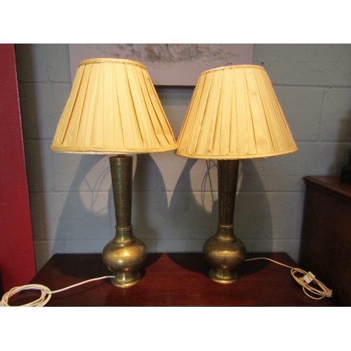 1075 - A pair of Indian brass table lamp bases with gold coloured pleated shades