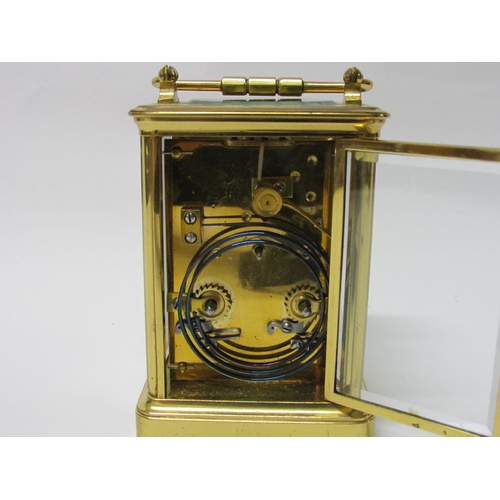 8082 - An early 20th Century brass cased carriage clock with 8-day movement striking on a gong. Arabic enam... 