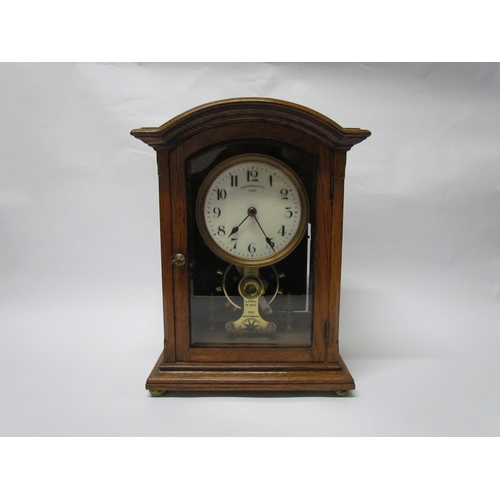 8036 - An early 20th Century oak cased Eureka clock with early electric movement and large balance wheel, A... 