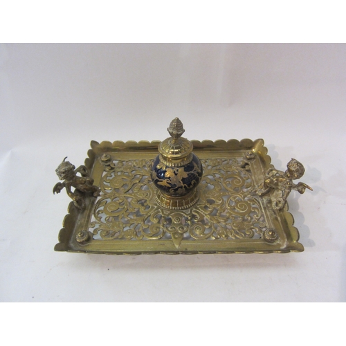 1436 - A pair of brass fire dogs and a pierced brass inkwell with cobalt blue globe