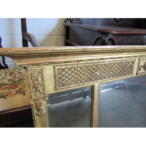 1016 - A 19th Century gilt and gesso three panel overmantel mirror with bevelled glass, urn and acanthus em... 