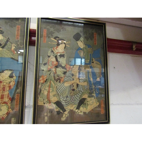 1022 - A set of three Japanese woodblock prints depicting figures in various scenes, each framed and glazed... 