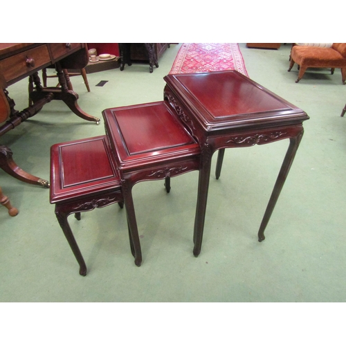 4015 - A nest of three graduating Chinese hardwood occasional tables with carved frieze, largest 66cm tall ... 