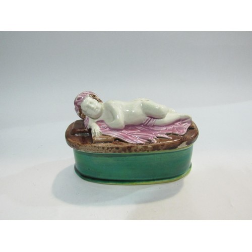 4324 - A Victorian majolica pin box with cherub design, 14cm long a/f   (R) £35