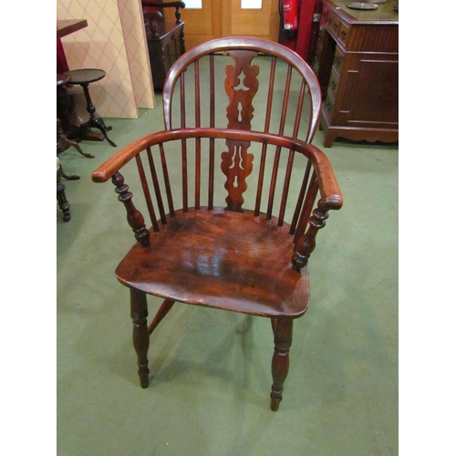 4002 - A circa 1830 elm and yew Windsor armchair with fretwork central splat and stick-back on turned legs ... 