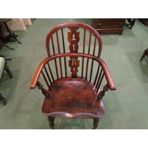 4002 - A circa 1830 elm and yew Windsor armchair with fretwork central splat and stick-back on turned legs ... 