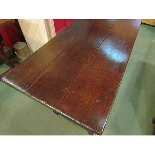 4028 - A pegged oak table top bench settle, the plank table top over scroll end arms on turned supports, th... 