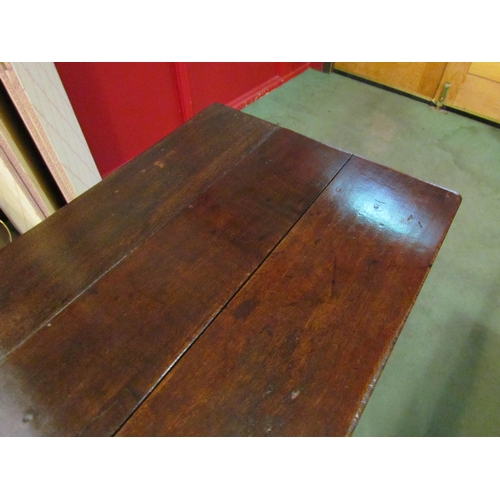 4028 - A pegged oak table top bench settle, the plank table top over scroll end arms on turned supports, th... 