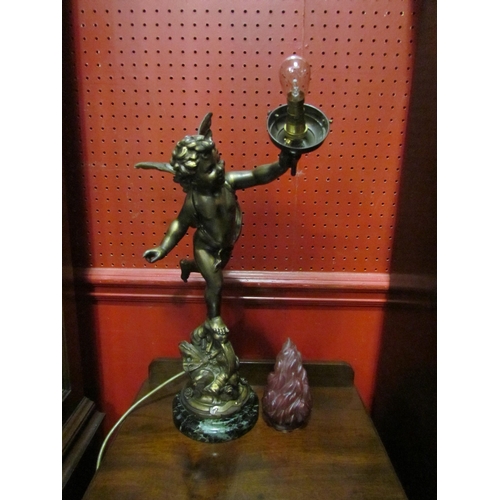 4036 - A gilt metal table lamp base in the form of a winged cherub holding flame shade aloft, bearing plaqu... 