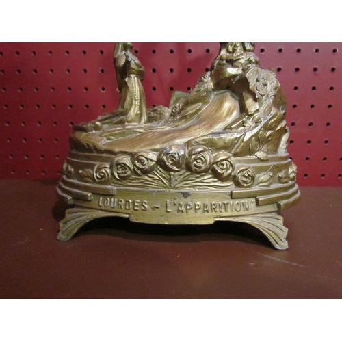 4047 - A French Lourdes gilt lamp base with religious theme, 27cm tall