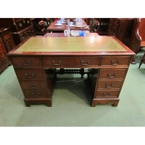 4074 - A reproduction mahogany eight drawer twin pedestal desk on bracket feet with gilt tooled leather top... 