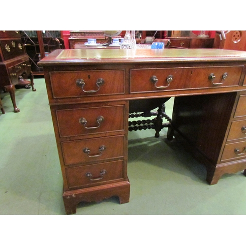 4074 - A reproduction mahogany eight drawer twin pedestal desk on bracket feet with gilt tooled leather top... 