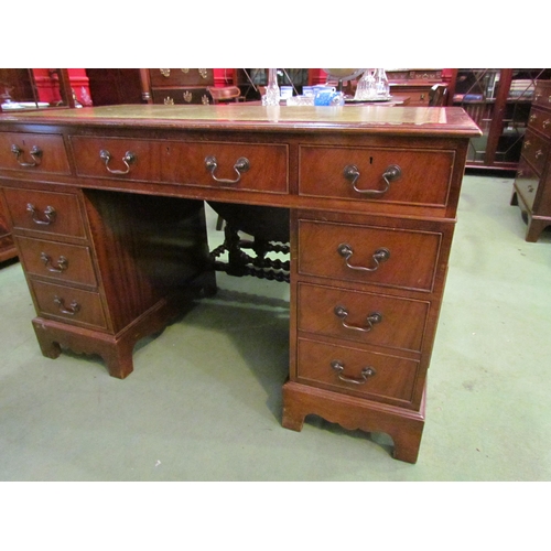 4074 - A reproduction mahogany eight drawer twin pedestal desk on bracket feet with gilt tooled leather top... 