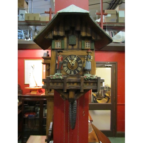 4075 - A cuckoo clock with figural detail, two weights