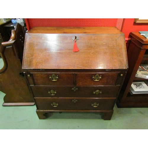 4081 - A George III country oak bureau with fitted interior over two short and two long drawers on bracket ... 