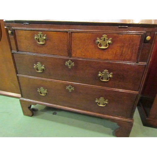 4081 - A George III country oak bureau with fitted interior over two short and two long drawers on bracket ... 