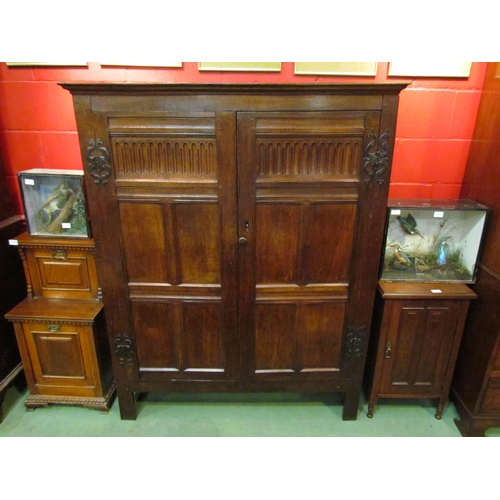 4131 - A 17th Century and later oak two door livery cupboard with carved panelled doors and ornate iron 