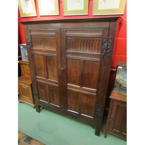 4131 - A 17th Century and later oak two door livery cupboard with carved panelled doors and ornate iron 