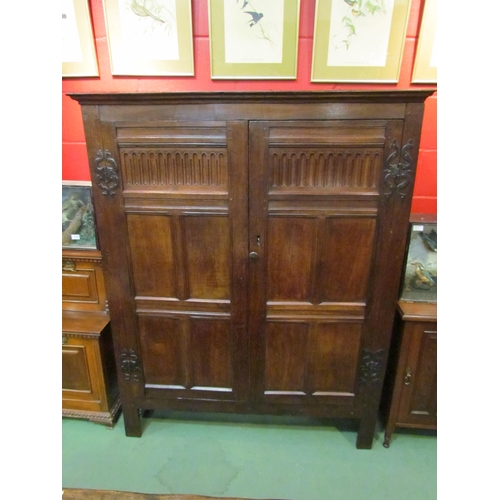 4131 - A 17th Century and later oak two door livery cupboard with carved panelled doors and ornate iron 