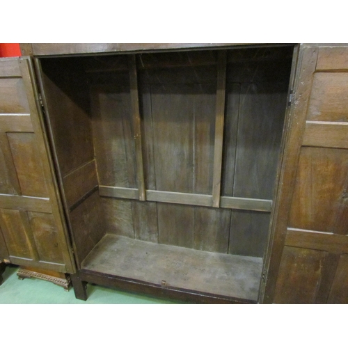 4131 - A 17th Century and later oak two door livery cupboard with carved panelled doors and ornate iron 