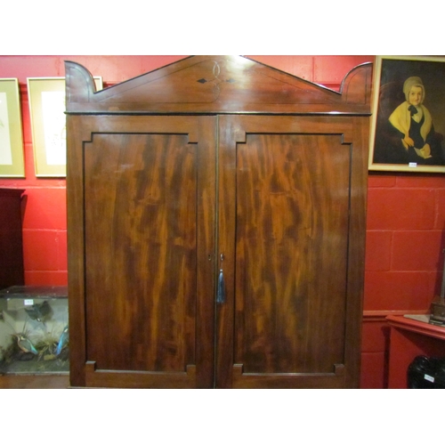 4134 - A Regency mahogany linen press with black line inlay, the two door and three tray interior with key ... 