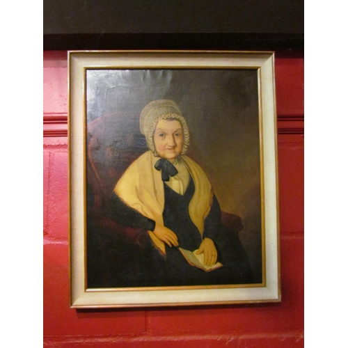 4136 - A Georgian oil on canvas of seated lady wearing bonnet with book, framed, 51cm x 41cm image size