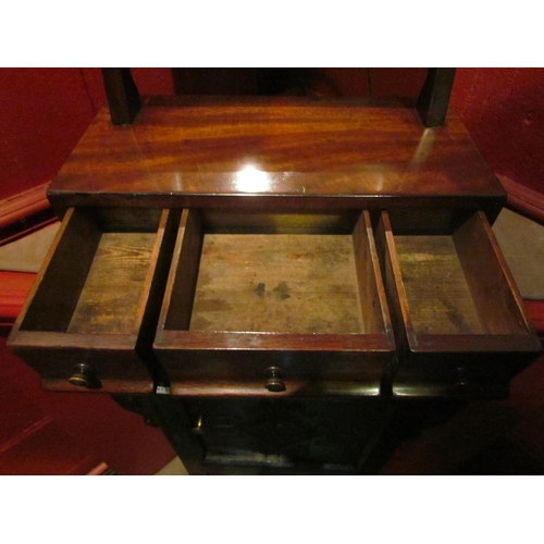 4137 - A 19th Century mahogany toilet mirror, the tilting mirror and brass finials over a three drawer base... 