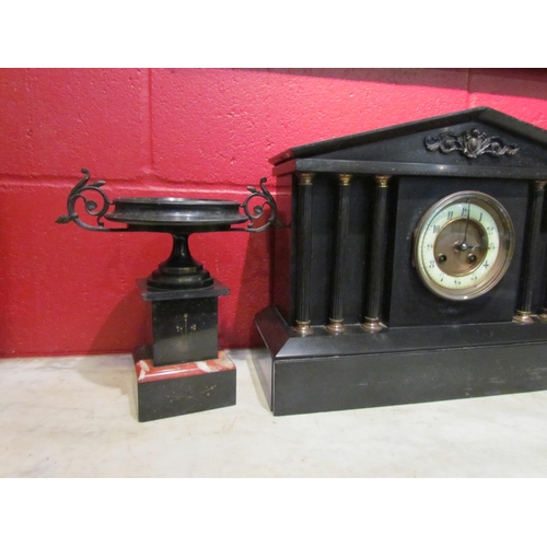 4148 - A slate mantel clock garniture of architectural and urn form, column supports, with key