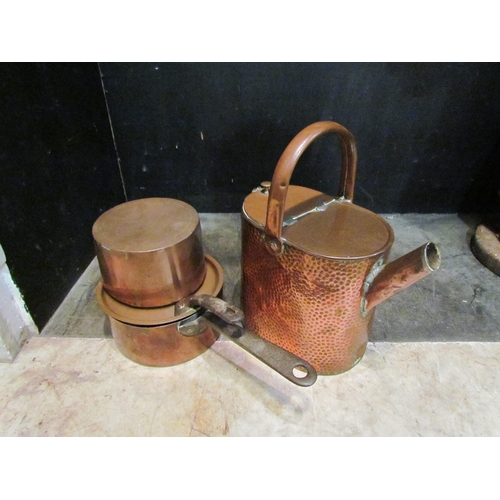 4149 - A planished copper watering can a/f, a lidded copper pan with wrought iron handles and one other cop... 