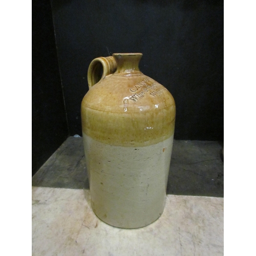 4152 - A large stoneware flagon advertising Cann & Clarke Wine & Spirit Merchants, Wymondham, 40cm tall