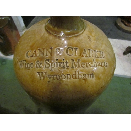 4152 - A large stoneware flagon advertising Cann & Clarke Wine & Spirit Merchants, Wymondham, 40cm tall