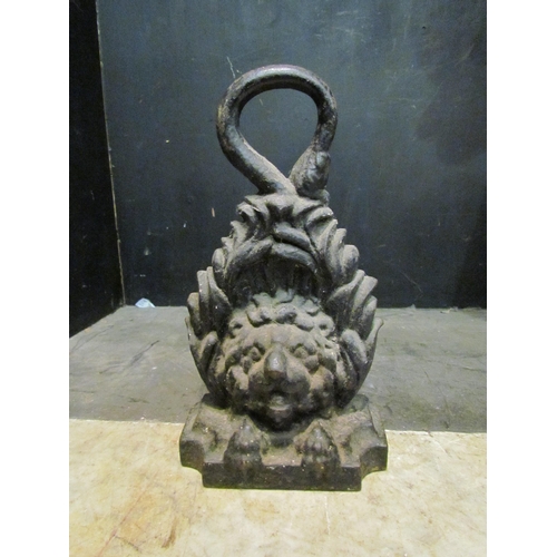 4155 - A cast iron doorstop of lion's head form, 29cm tall