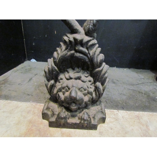 4155 - A cast iron doorstop of lion's head form, 29cm tall