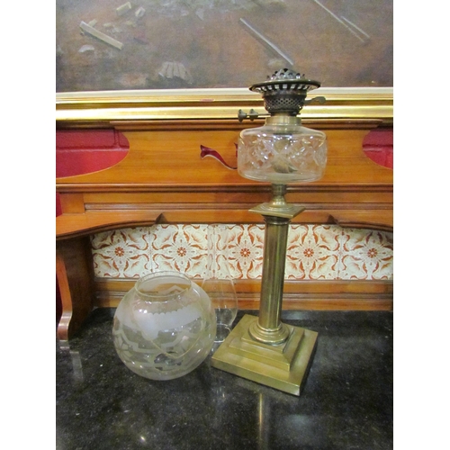 4158 - A Victorian brass oil lamp, the frosted globular glass shade (a/f) over a cut glass reservoir to a b... 