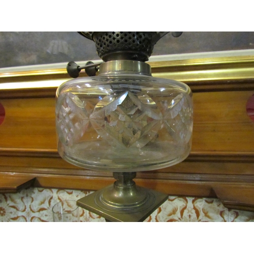 4158 - A Victorian brass oil lamp, the frosted globular glass shade (a/f) over a cut glass reservoir to a b... 