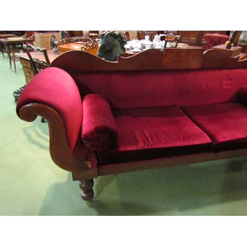 4164 - A Victorian scroll end sofa on turned legs with castors with red velour upholstery and bolster cushi... 