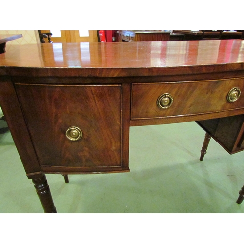 4178 - A George III flame mahogany bow-front sideboard of three drawers over turned and tapering leg suppor... 