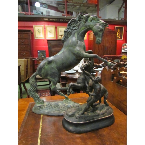 4181 - A cast metal figure of Marley horse with groom on plinth base, 23cm tall, and a large metal figure o... 