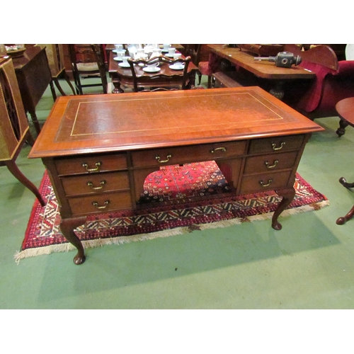 4185 - A Georgian mahogany desk of seven drawers, the gilt tooled leather writing insert over a central kne... 