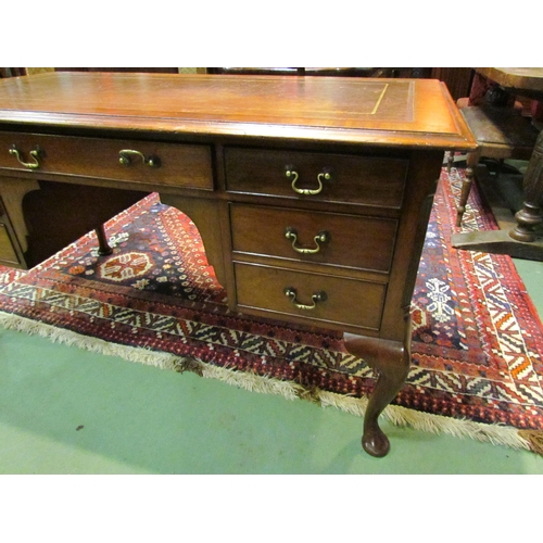 4185 - A Georgian mahogany desk of seven drawers, the gilt tooled leather writing insert over a central kne... 