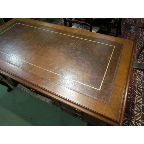 4185 - A Georgian mahogany desk of seven drawers, the gilt tooled leather writing insert over a central kne... 