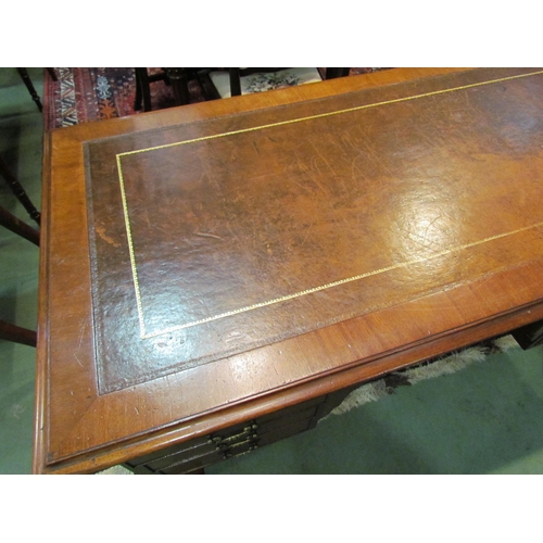 4185 - A Georgian mahogany desk of seven drawers, the gilt tooled leather writing insert over a central kne... 