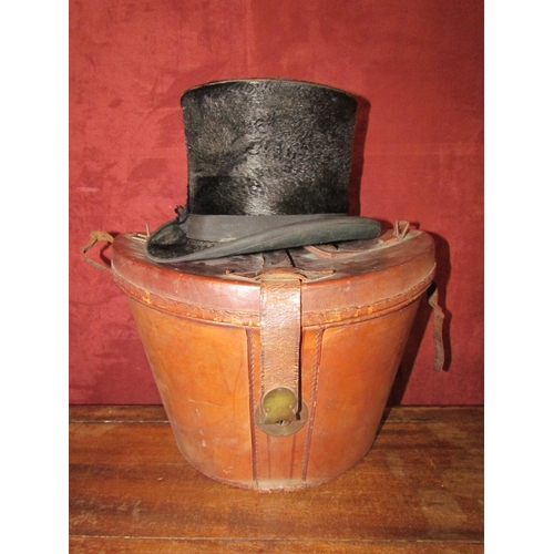 4193 - A vintage brown leather hat box with a top hat, a/f