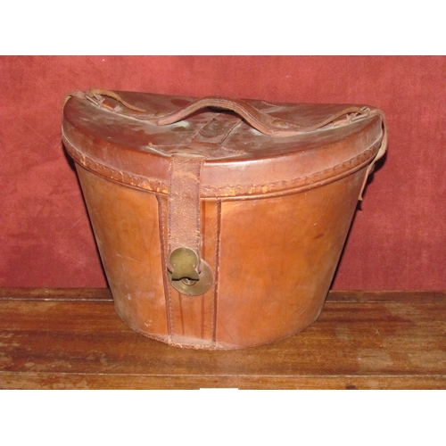 4193 - A vintage brown leather hat box with a top hat, a/f